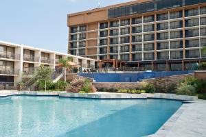 a swimming pool in front of a large building at Treasure Bay Casino & Hotel-Adults Age 21 and Above in Biloxi