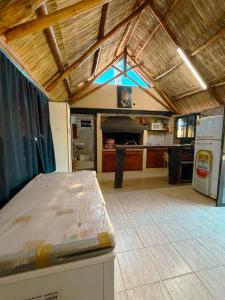 a large room with a kitchen and a table at ParaisolaRinconada in La Porteña