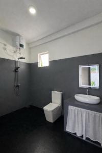 a bathroom with a toilet and a sink at Hideaway in Bentota