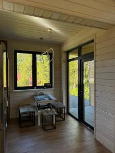 a screened in porch with a table and benches at Luxury Home in Slavske