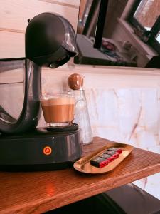 a coffee maker sitting on top of a wooden table at Luxury Home in Slavske