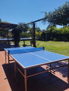 a tennis court with a blue table tennis at ParaisolaRinconada in La Porteña