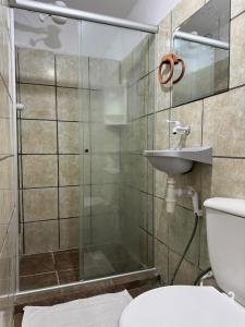 a bathroom with a shower and a toilet and a sink at Casa Aeroporto Pousada in Recife +123 photos