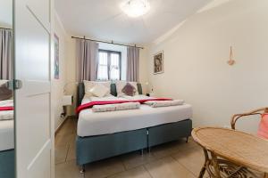 a bedroom with a bed and a table at Naturoase Mühlviertel in Sankt Johann am Wimberg
