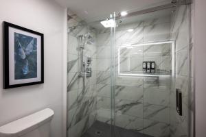 a bathroom with a shower with a glass door at Miccosukee Casino & Resort in Miami +41 photos