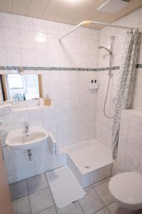 a white bathroom with a sink and a shower at Hotel Spilburg in Wetzlar +20 photos