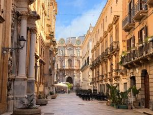 an alley in a city with buildings at Albergo Russo in Trapani