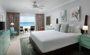 a bedroom with a bed and a view of the ocean at Mango Bay All Inclusive in Saint James