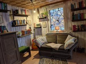 a living room with a couch and a window at Wohnung am Waldrand in Lerbach +39 photos