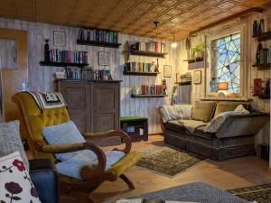 a living room with a couch and a chair at Wohnung am Waldrand in Lerbach