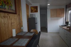 a small kitchen with a table and a refrigerator at Ferienwohnug Home in Gotha +6 photos