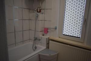 a bathroom with a shower and a tub and a toilet at Ferienwohnug Home in Gotha