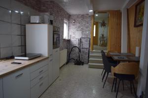 a kitchen with a refrigerator and a table and a dining room at Ferienwohnug Home in Gotha