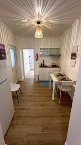 a kitchen with a table and a kitchen with a counter at Raiz Atlântica in Angra do Heroísmo