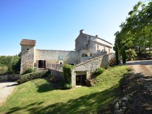 an external view of a stone house with a yard at Castle near Agen with Shared Pool in Saint-Caprais-de-Lerm