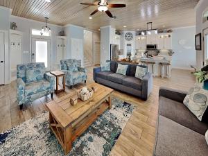 a living room with two couches and a coffee table at Postcard from Paradise in Padre Island