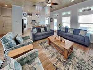a living room with two couches and a coffee table at Postcard from Paradise in Padre Island