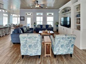 a living room with two couches and a table at Postcard from Paradise in Padre Island