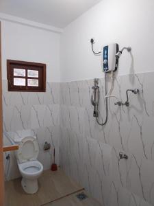 a bathroom with a toilet and a shower at Villa Anu in Hikkaduwa +16 photos