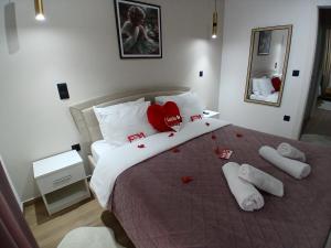 a bedroom with a bed with red hearts on it at Apartment Debrova in Alexandroupoli