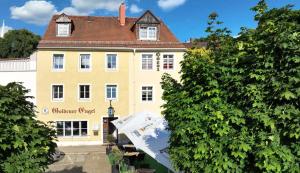 a large yellow building with a brown roof at Goldener Engel /Pension in Görlitz
