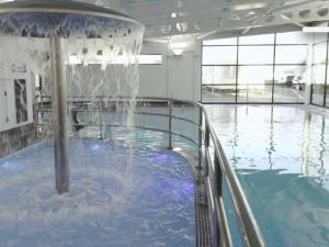 a swimming pool with a water fountain in a building at C43 The Hideout in Rowen