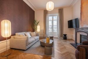 a living room with a couch and a fireplace at Le Dubedout - Hyper Centre - Bastille in Grenoble