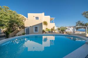 a swimming pool in front of a villa at Ersi Villas in Firostefani