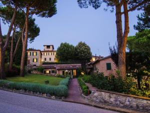 a house with a garden and a driveway at Villa in Siena with Pool and Tuscan Views in Siena