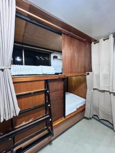 a room with two bunk beds and a ladder at Blueka Hostel Ko Chang in Khlaung Phai Bae