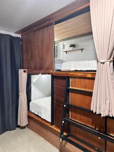 a room with a bunk bed with a mirror at Blueka Hostel Ko Chang in Khlaung Phai Bae