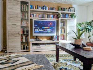 a living room with a large entertainment center with a tv at Wohnung am Waldrand in Lerbach