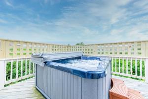 a hot tub on a deck with a fence at Crow's Nest - Corolla, Crown Point, 150 Yds to Beach, Hot Tub, Community Pool, Pets OK in Corolla