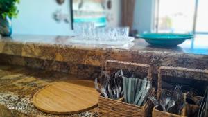a counter with a basket of utensils on it at Villa Arkoi in Uaymitun +59 photos