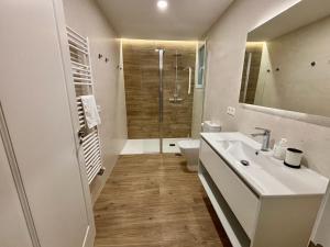 a bathroom with a toilet and a sink and a shower at Espacios Blanco Santiago in Valladolid +36 photos