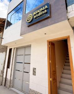 a sign on the side of a building with a door at Aruma Andina Hotel CHAVÍN in Chavín de Huantar +15 photos
