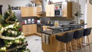 a kitchen with a christmas tree in a kitchen at Le petit Flotteur in Chevroches