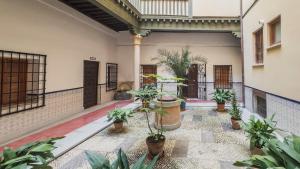 an indoor courtyard with potted plants in a building at Sweet Home by Toledo AP in Toledo