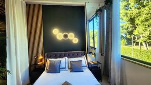 a bedroom with a bed and a large window at Park & Seafront Pescara in Montesilvano +13 photos