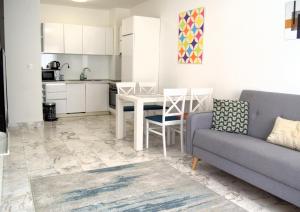 a living room with a couch and a table at Yeshill Deluxe Apartment in Budva