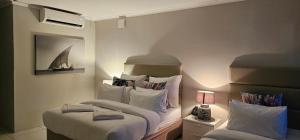 a bedroom with two beds and a sailboat on the wall at Breakers Resort Apartment 314 in Durban