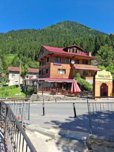 a large building with a restaurant on the side of a street at Simal Apart Ev in Ayder Yaylasi