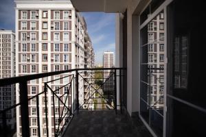 a balcony with a view of a city with tall buildings at MYFREEDOM апартаменти в ЖК Нова Англія, Британський квартал in Kyiv