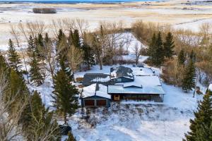 an aerial view of a house in the snow at Executive Acreage 3 King Beds Fireplace AC in Airdrie