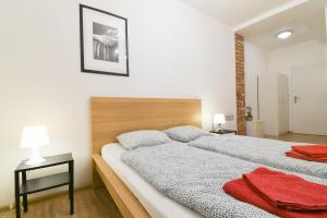 a bedroom with a large bed with a wooden headboard at Penzion Zacha se sklípkem in Vracov