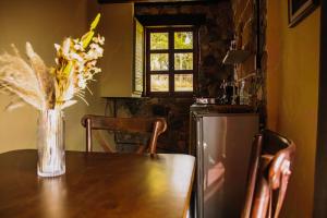 a vase of flowers sitting on a table in a kitchen at La Magia del Bosque in Puebla +10 photos