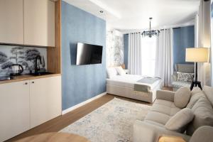 a living room with a couch and a bed at MYFREEDOM апартаменти в ЖК Нова Англія, Британський квартал in Kyiv