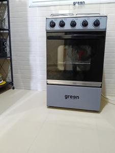 a oven sitting on a white floor in a kitchen at GALSEN LODGe in Thiès