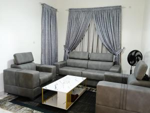 a living room with two couches and a coffee table at GALSEN LODGe in Thiès