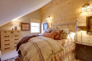 a bedroom with a bed and a wooden wall at Boulder Dreams! Mtn-View Gem in McLeod in McLeod